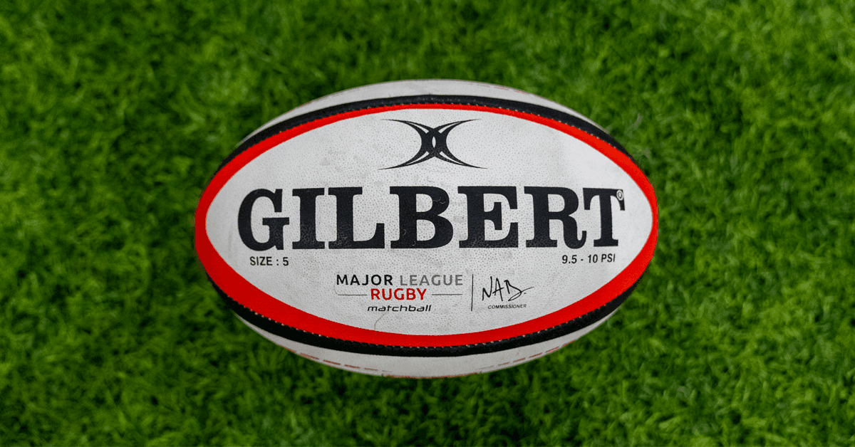 A young player holds a rugby ball during a Seattle Seawolves community program.