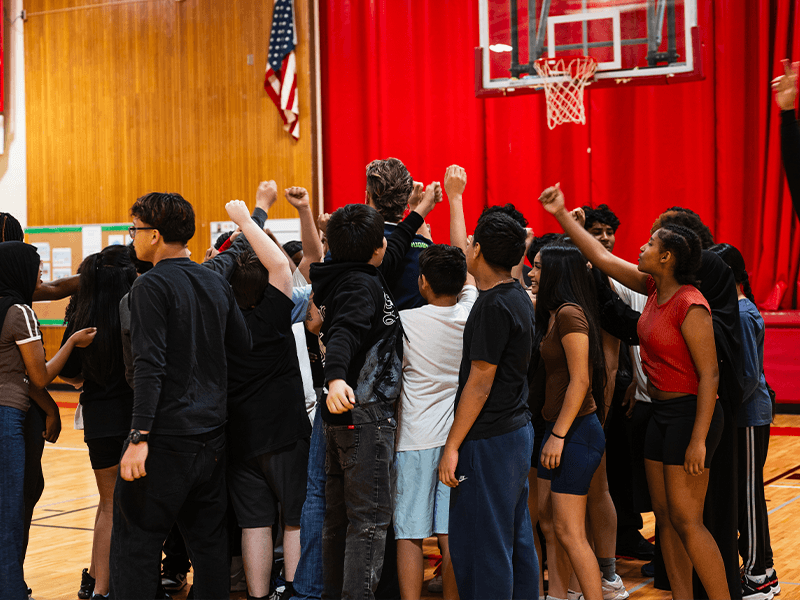 Seawolves players visit local students during a school rugby program.