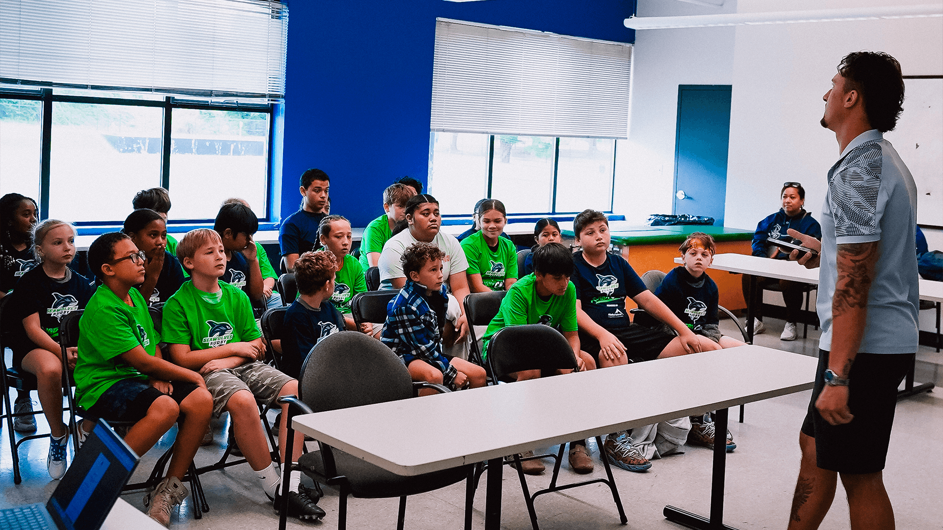 A Seawolves player speaks to a classroom of students during a school visit