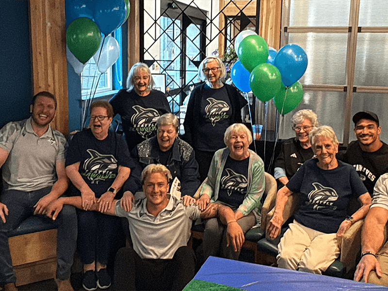 Seawolves staff and community members gather at a local event.