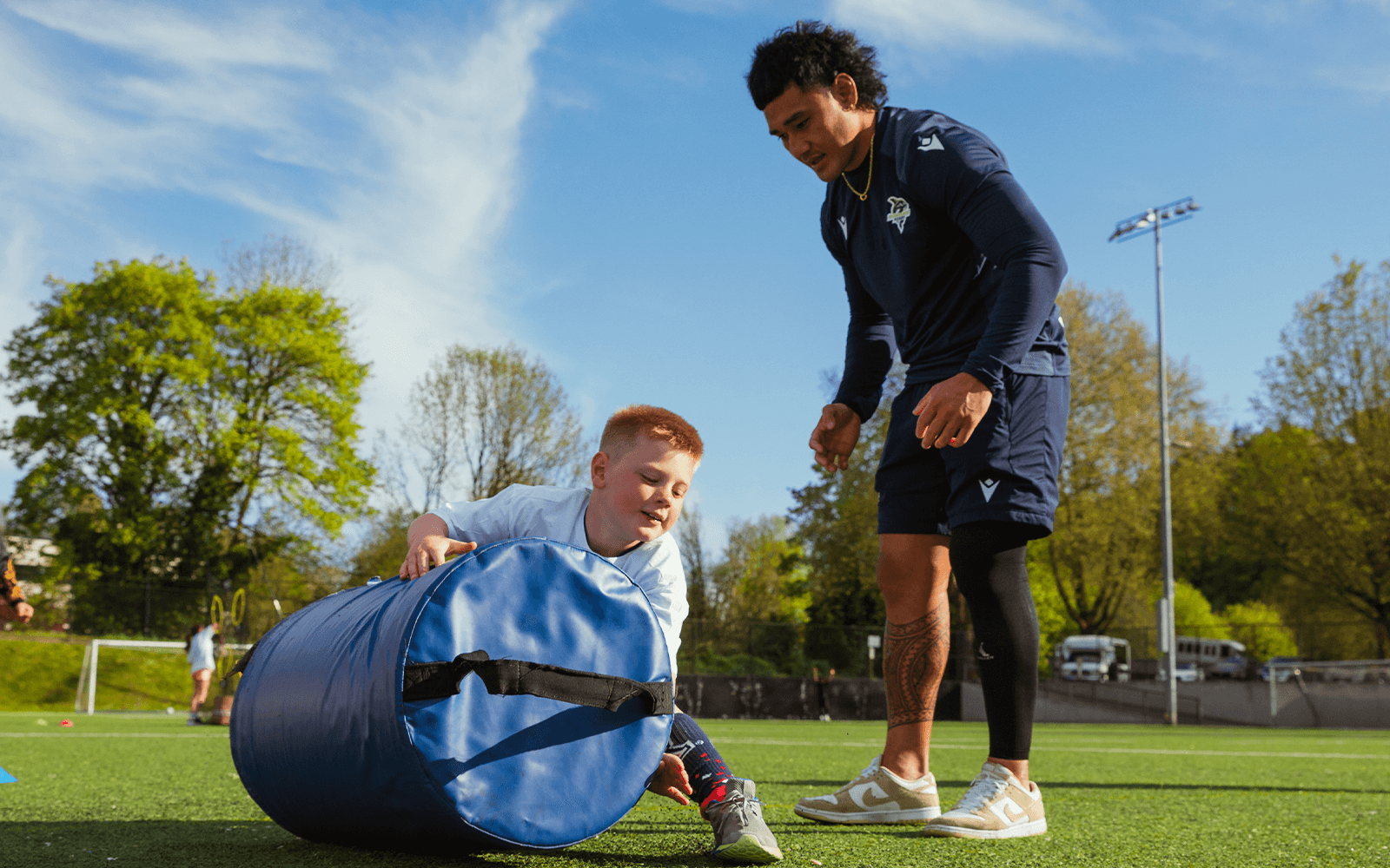 Seattle Seawolves players and coaches lead a youth rugby session.